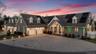 View of front of property featuring decorative driveway, a shingled roof, a garage, and roof mounted solar panels