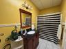 Bathroom featuring vanity, tile patterned floors, a drop ceiling, a shower with curtain, and toilet