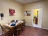 Dining space featuring light wood-type flooring, baseboards, and a drop ceiling