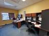 Home office with a paneled ceiling, dark carpet, and baseboards