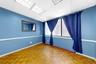 Empty room featuring a drop ceiling and baseboards