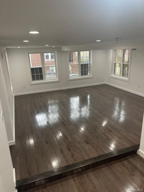 Living room featuring dark wood-style flooring