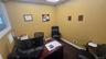 Office area featuring a drop ceiling and dark carpet