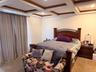 Carpeted bedroom featuring coffered ceiling, beamed ceiling, ornamental molding, and recessed lighting