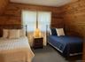Bedroom featuring wooden walls and carpet