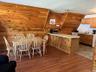 Dining area featuring dark wood-type flooring and wooden walls