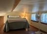 Bedroom with wood finished floors and baseboards