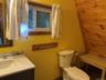 Half bathroom featuring vanity and toilet