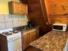 Kitchen with white appliances, brown cabinets, and backsplash