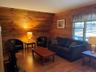 Living room featuring wooden walls and wood finished floors
