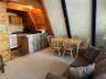 Dining space featuring lofted ceiling and dark carpet