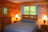 Bedroom featuring wood walls