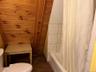 Bathroom featuring toilet and shower / bath combo