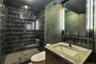 Full bath with black tile plaster walls