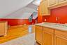 Kitchen featuring light brown cabinetry, light tile patterned floors, and lofted ceiling