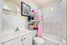 Full bathroom with shower / bath combination with curtain and vanity