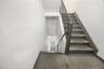 Stairs with concrete flooring and baseboards