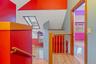 Hallway featuring light wood finished floors, an upstairs landing, and a skylight