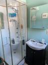 Bathroom featuring vanity and a shower with shower door