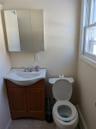 Bathroom featuring toilet, tile patterned flooring, vanity, and a baseboard heating unit