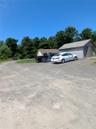View of vehicle parking with a storage shed
