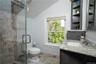 Bathroom featuring vanity, toilet, vaulted ceiling, and a shower with shower door