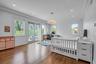 Main Floor Primary Bedroom with Ensuite Bath, wood finished floors, Custom Walk in Closet, crown molding, recessed lighting, and access to outside