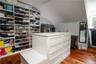Spacious closet featuring lofted ceiling and light wood-type flooring