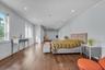 Second Floor Primary Bedroom with Ensuite Spa Bathroom, ornamental molding, multiple windows, wood finished floors, and recessed lighting