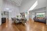 Forml Dining Room featuring  a towering 20' ceiling, wood finished floors, crown molding, and a chandelier