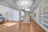 Entrance foyer featuring wood finished floors, a chandelier, stairs, recessed lighting, and a tray ceiling