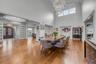 Formal Dining room with a chandelier, ornamental molding, light wood-style flooring, coffered ceiling, and a towering 20' ceiling