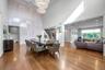Formal Dining Room featuring wood finished floors, a 20' ceiling, and a chandelier