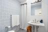 Bathroom featuring tile walls and curtained shower
