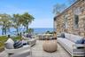 Wooden deck featuring an outdoor living space, a water view, and outdoor dining space