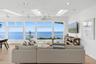 Living room featuring light wood-style flooring, healthy amount of natural light, recessed lighting, ceiling fan, and a skylight