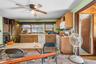 Kitchen with white appliances, light countertops, and ceiling fan
