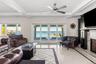 Living area featuring inlaid floor details, coffered ceiling, french doors, beam ceiling, and ornamental molding