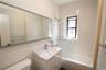 Full bath featuring shower / bathtub combination, vanity, and tile walls
