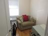 Sitting room featuring radiator heating unit and light wood finished floors