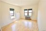 Unfurnished room with radiator and wood finished floors