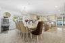 Dining space with recessed lighting, a chandelier, and dark aggregate flooring