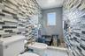 Bathroom featuring tile walls, walk in shower, a bidet, tile patterned floors, and ornamental molding