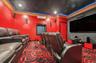 Home theater with crown molding and a wall unit AC