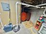 Utilities with electric panel, oil tank, and drainage system
