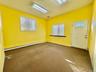 Carpeted entrance foyer featuring a baseboard heating unit