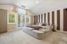 Bedroom with vaulted ceiling, carpet flooring, access to outside, recessed lighting, and wallpapered walls