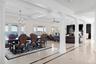Dining area featuring decorative columns, ornamental molding, a chandelier, inlaid floor details, and coffered ceiling