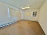 Carpeted empty room with baseboard heating