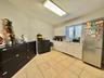 Kitchen with appliances with stainless steel finishes, white cabinets, light tile patterned floors, and light countertops